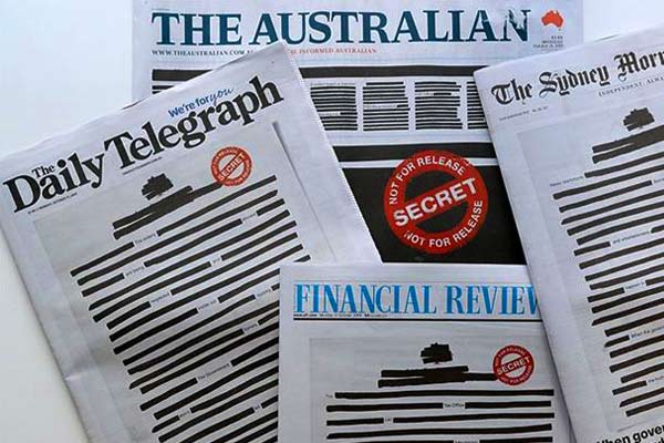 Australia Newspaper Blackout out text beside red stamps Australia Newspaper Blackout out text beside red stamps